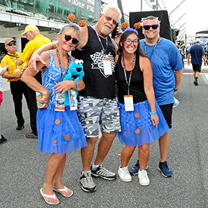 A family poses on pit lane